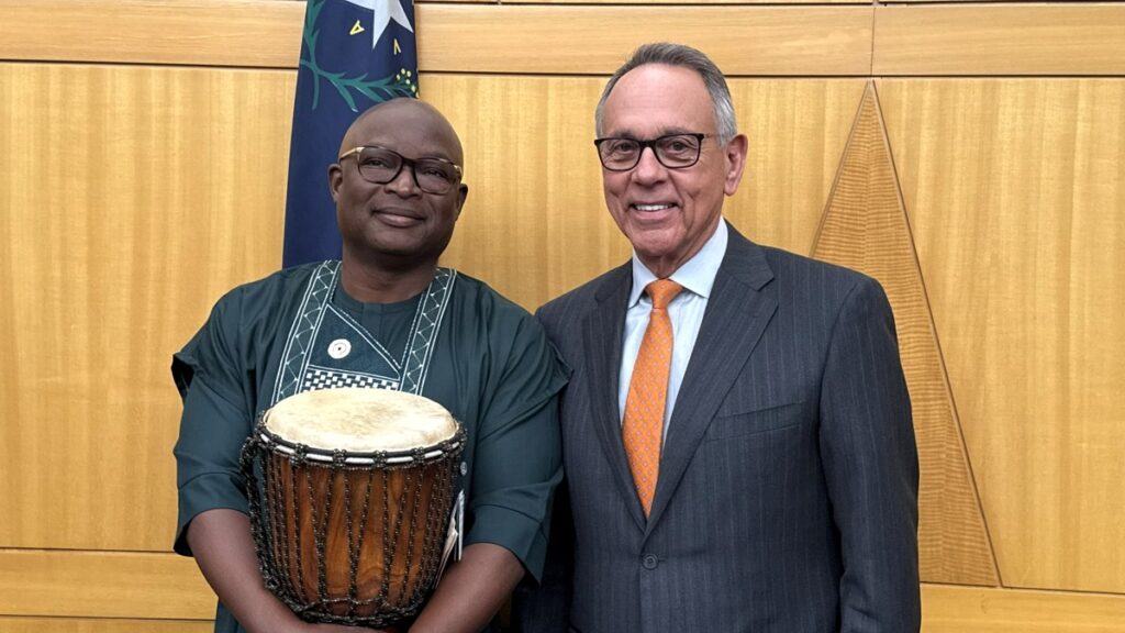 Commissioner Jim Gibson (right) recognizes a community leader during Clark County&rsquo;s Black History Month observance.
