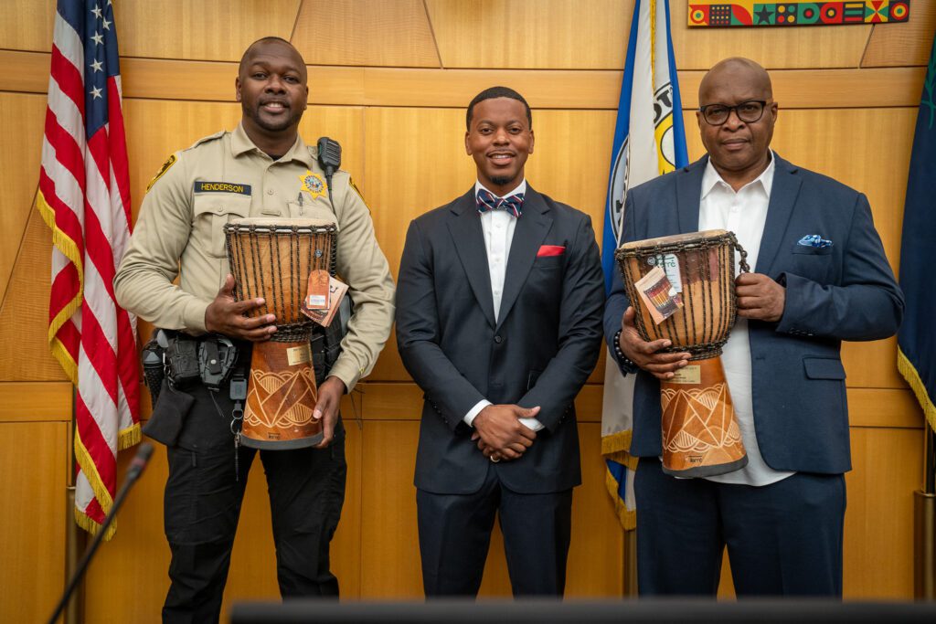 Commissioner William McCurdy II (right) recognizes Dwayne Henderson for community-centered policing efforts.