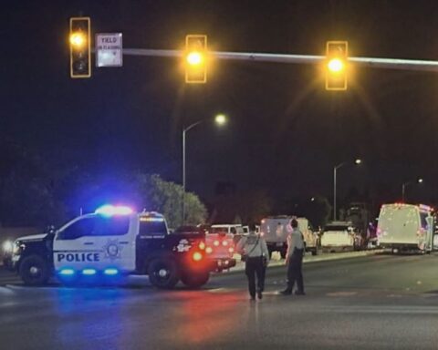 A Las Vegas police officer was shot at a southwest valley home before SWAT officers found a male suspect and female juvenile dead, LVMPD says