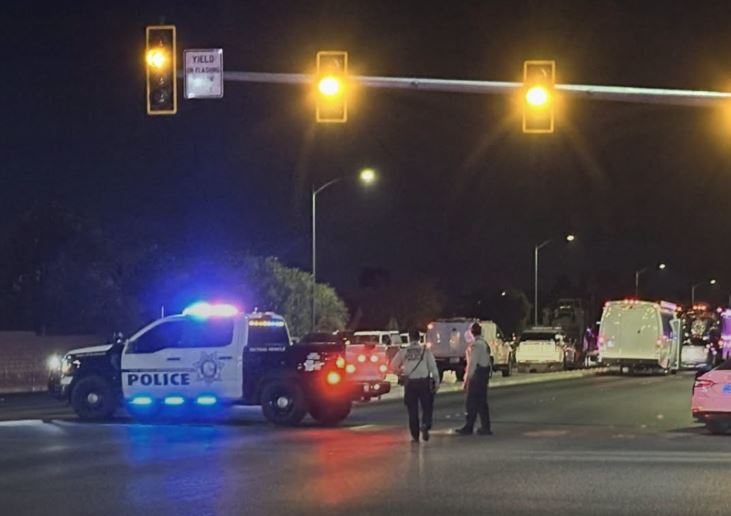 A Las Vegas police officer was shot at a southwest valley home before SWAT officers found a male suspect and female juvenile dead, LVMPD says