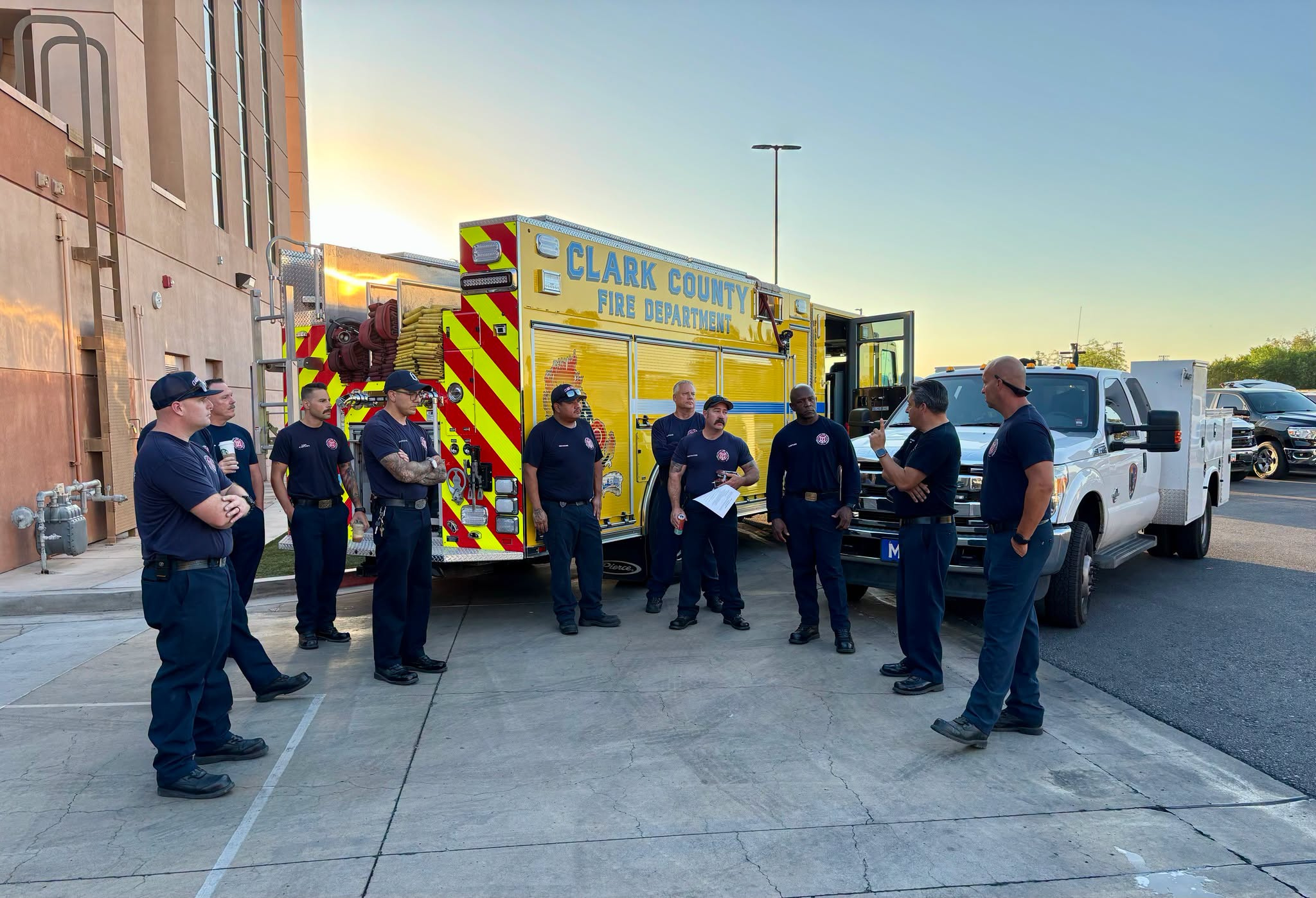 Clark County firefighters gathered beside fire apparatus before deployment to Elko County
